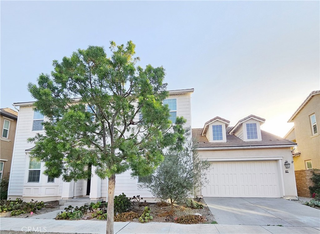 61 Windwalker Way Tustin, CA 92782 - Photo 2 of 16 a front view of a house with a garden