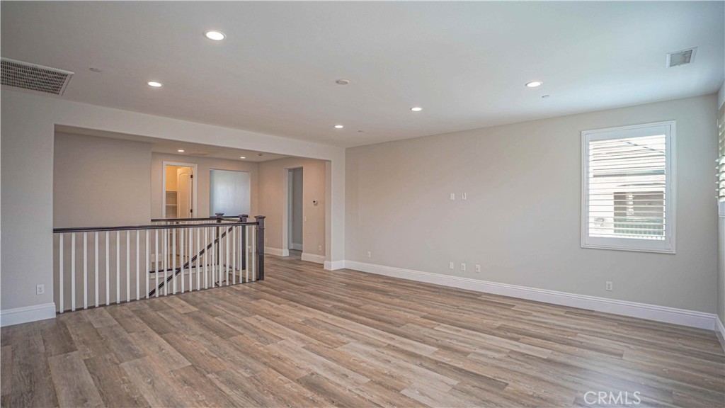 61 Windwalker Way Tustin, CA 92782 - Photo 9 of 16 a view of hallway with wooden floor
