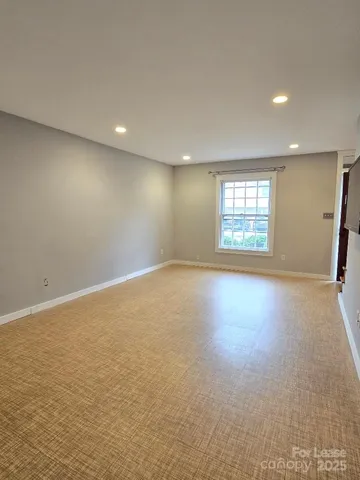 an empty room with a empty space and windows