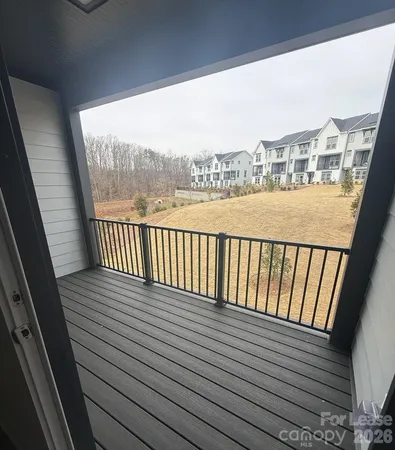 a view of balcony with wooden floor