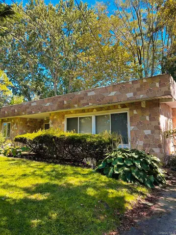 a front view of house with yard space and outdoor seating