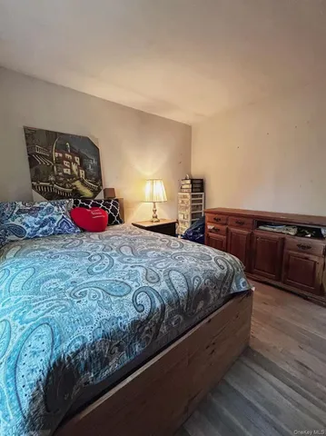 a bedroom with a bed and a couch