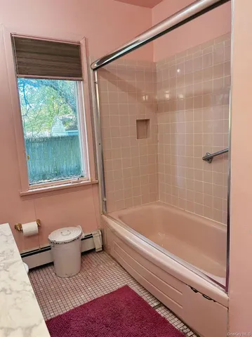 a bathroom with a bathtub and a shower