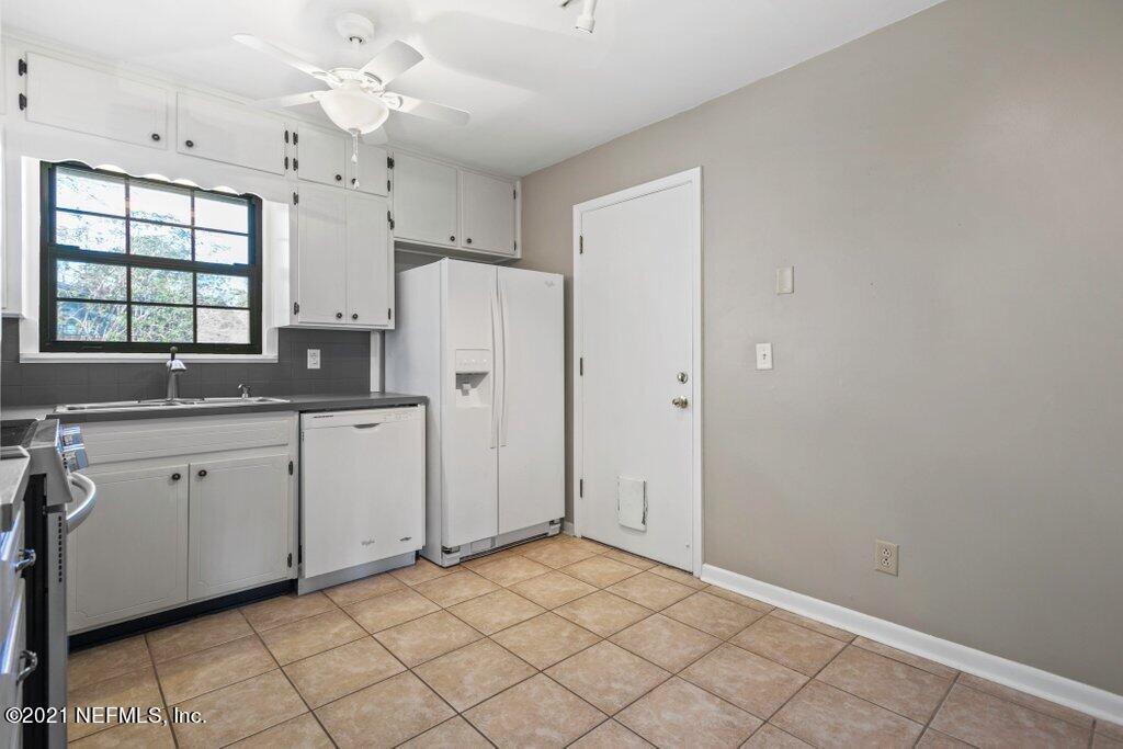 5115 Brighton Drive Jacksonville, FL 32217 - Photo 11 of 37 a kitchen with cabinets and window