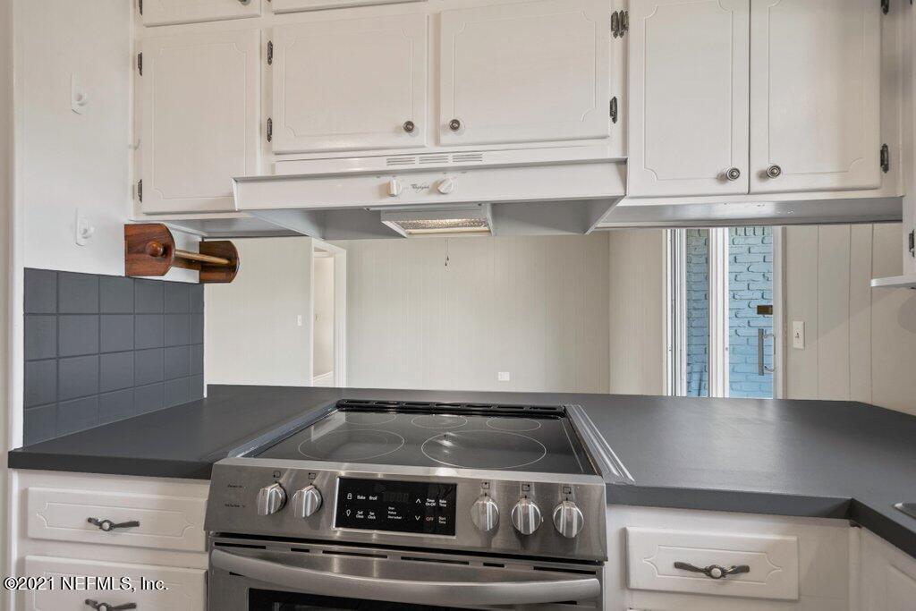 5115 Brighton Drive Jacksonville, FL 32217 - Photo 13 of 37 a stove top oven sitting inside of a kitchen