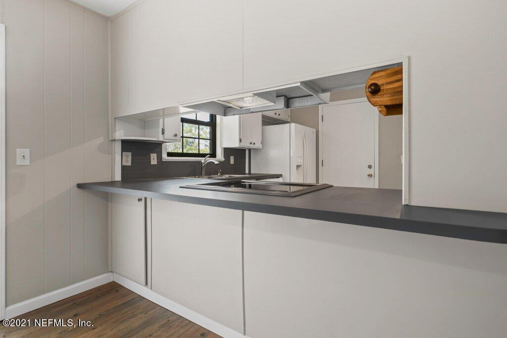 5115 Brighton Drive Jacksonville, FL 32217 - Photo 16 of 37 a kitchen with a sink cabinets and wooden floor