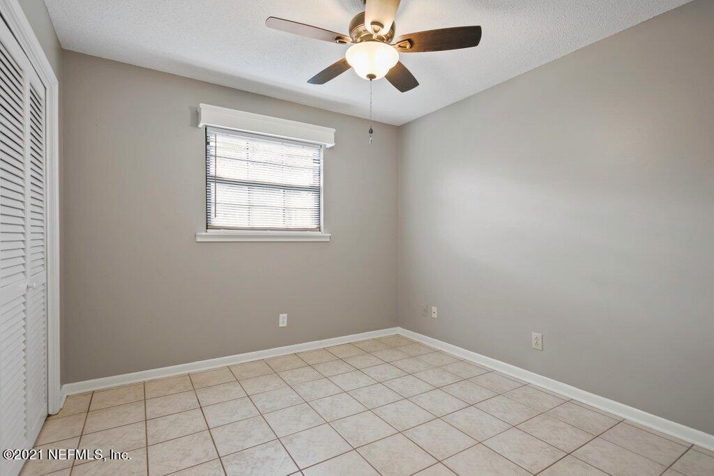 5115 Brighton Drive Jacksonville, FL 32217 - Photo 22 of 37 an empty room with chandelier fan