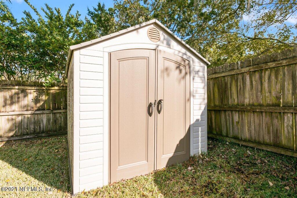 5115 Brighton Drive Jacksonville, FL 32217 - Photo 32 of 37 a view of backyard of small house with wooden fence