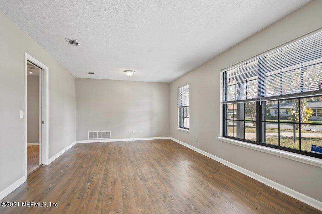 5115 Brighton Drive Jacksonville, FL 32217 - Photo 8 of 37 a view of an empty room with a window and wooden floor