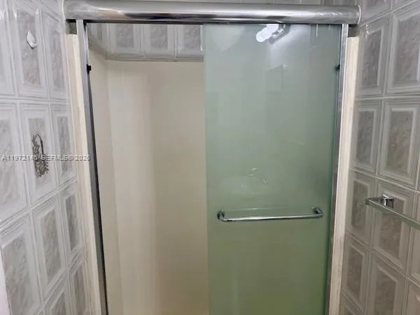 a bathroom with a glass shower door