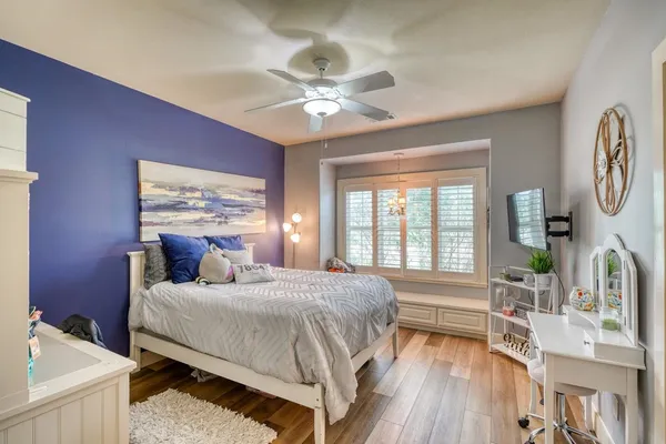 a bedroom with a bed and a chandelier