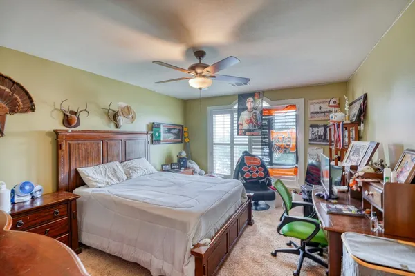 a bedroom with furniture and a chandelier