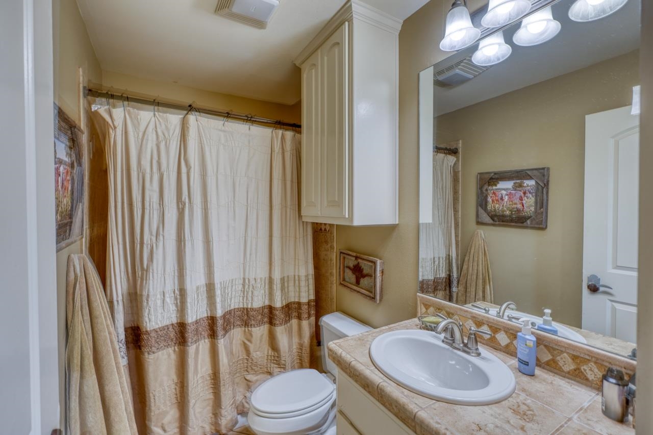 791 Ranch Road 2323 Llano, TX 78643 - Photo 17 of 30 a bathroom with a double vanity sink and a mirror