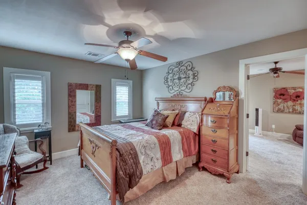 a bedroom with a bed and a chandelier