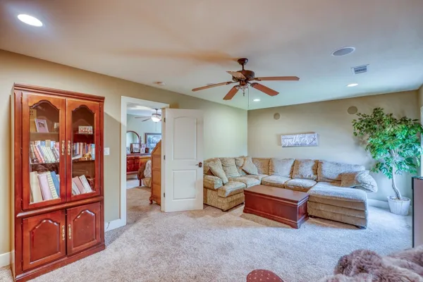 a living room with furniture cabinets and window
