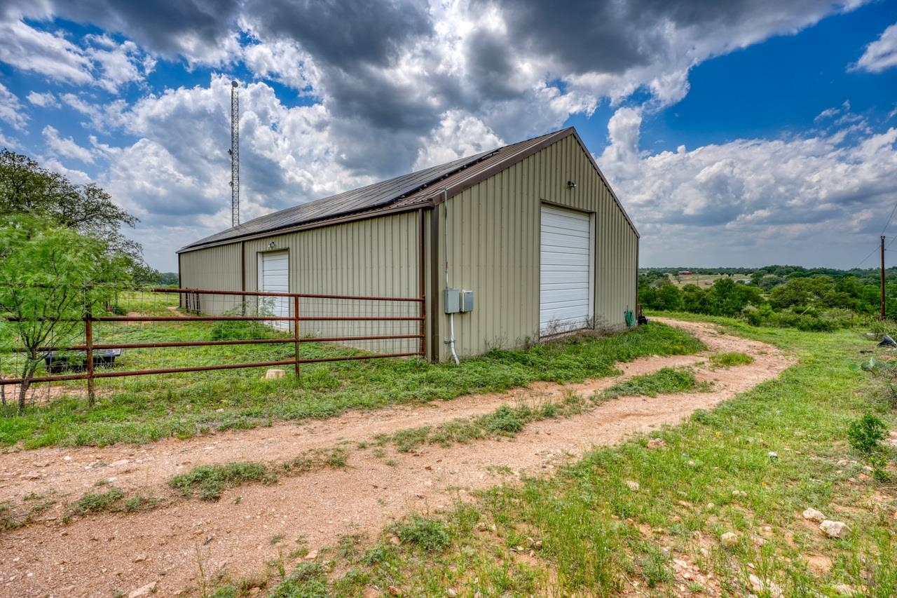 791 Ranch Road 2323 Llano, TX 78643 - Photo 20 of 30 a backyard of a house with plants and large tree