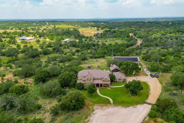 an aerial view of a house with garden space and street view