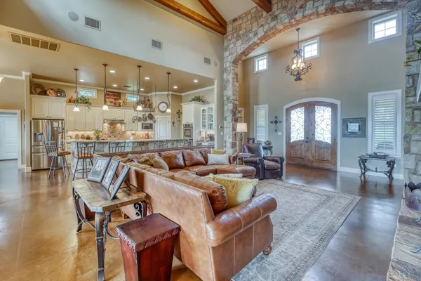 a living room with furniture and a mirror