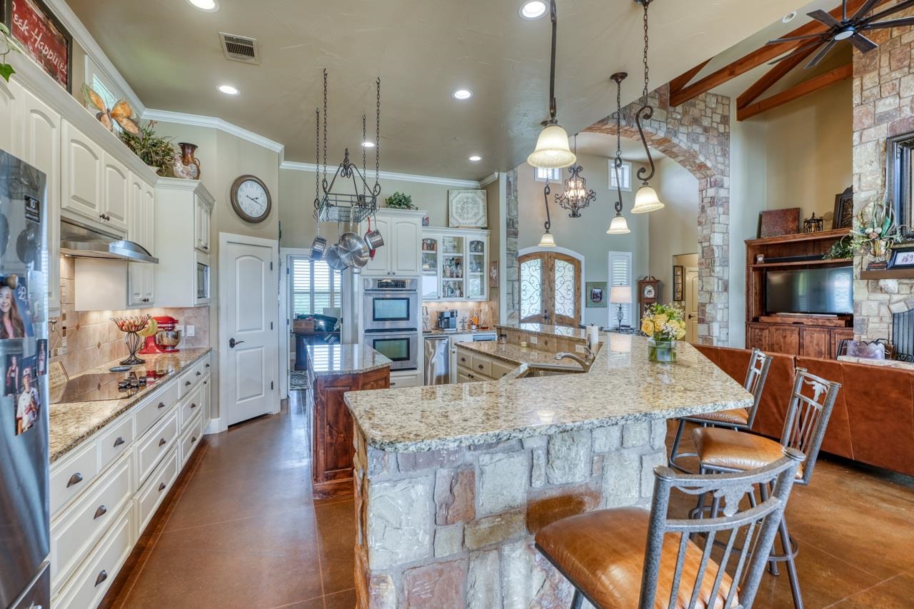 791 Ranch Road 2323 Llano, TX 78643 - Photo 7 of 30 a view of a dining room with furniture and chandelier