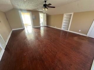 611 Chestnut Street Bonham, TX 75418 - Photo 12 of 14 an empty room with wooden floor ceiling fan and windows