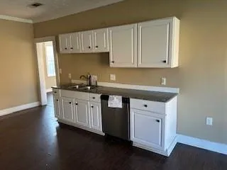 a kitchen with stainless steel appliances granite countertop a sink a stove and a refrigerator