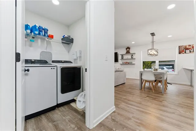 a kitchen with a refrigerator and a dining table