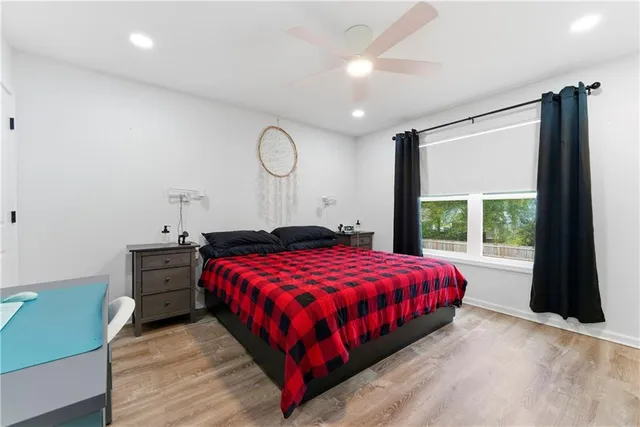 a bed sitting in a bedroom next to a window