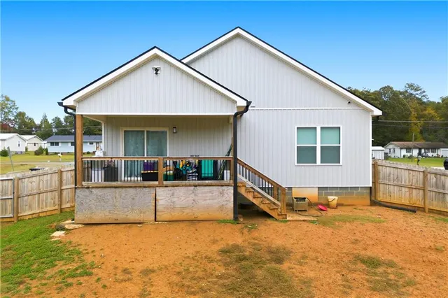 a view of a house with backyard and sitting area