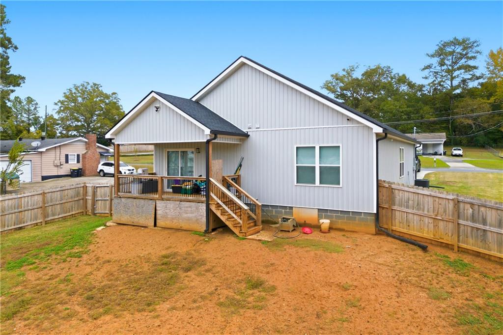 62 Dude Street Northwest Rome, GA 30165 - Photo 22 of 22 a white house with a large pool and wooden fence