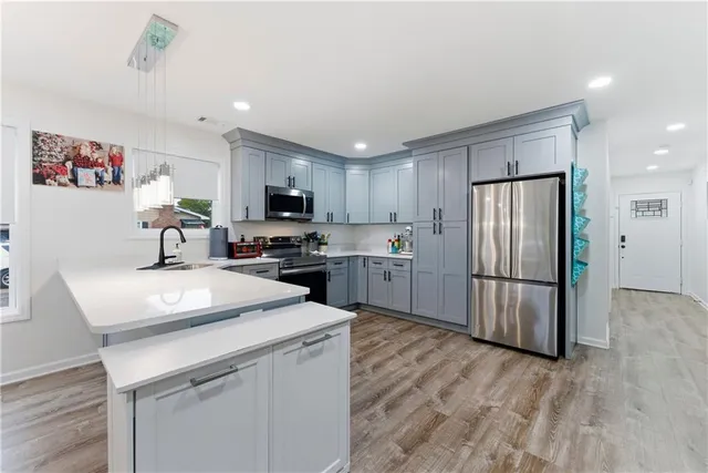 a kitchen with a refrigerator a sink and cabinets