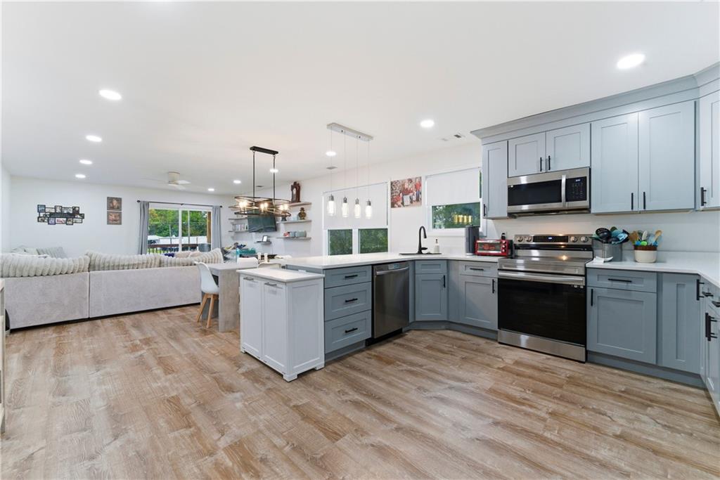 62 Dude Street Northwest Rome, GA 30165 - Photo 8 of 22 a kitchen with a sink cabinets and wooden floor