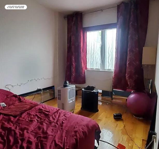 342 53rd Street, Unit 3F Brooklyn, NY 11220 - Photo 2 of 5 a bedroom with a bed and dresser