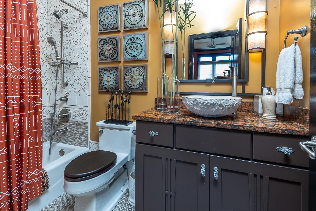 573 South Front Street Memphis, TN 38103 - Photo 22 of 40 a bathroom with a granite countertop toilet sink and mirror