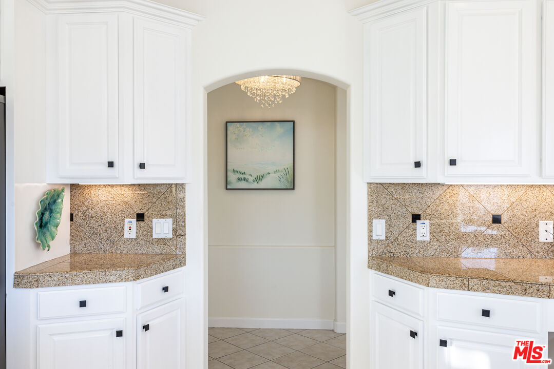 5101 Breakwater Way Oxnard, CA 93035 - Photo 11 of 39 a bathroom with a granite countertop sink and mirror