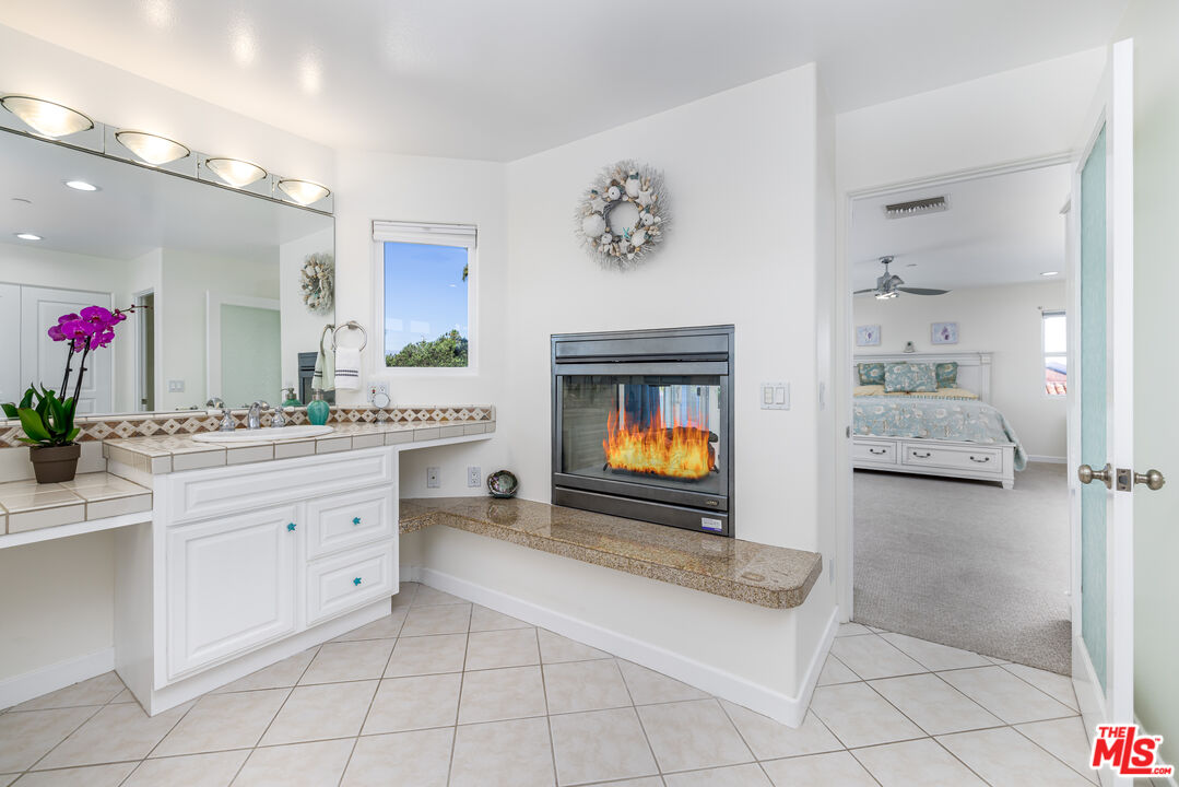5101 Breakwater Way Oxnard, CA 93035 - Photo 20 of 39 a spacious en suite bathroom with a granite countertop sink and a mirror