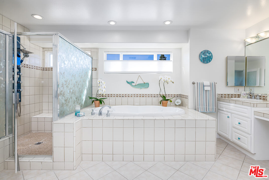 5101 Breakwater Way Oxnard, CA 93035 - Photo 22 of 39 a bathroom with a double vanity sink mirror and shower