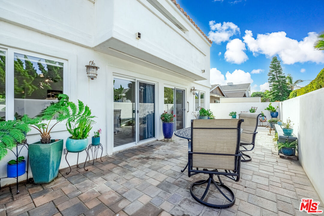 5101 Breakwater Way Oxnard, CA 93035 - Photo 34 of 39 a view of a patio with table and chairs and potted plants