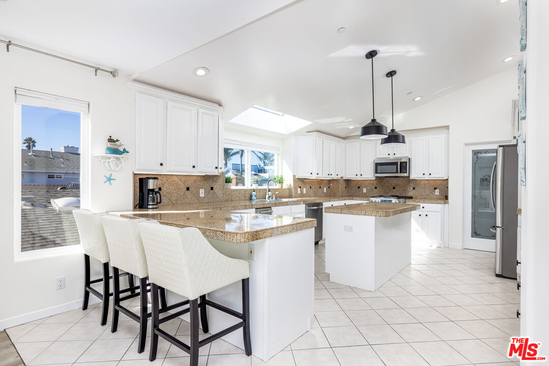 5101 Breakwater Way Oxnard, CA 93035 - Photo 6 of 39 a kitchen with appliances cabinets and chair