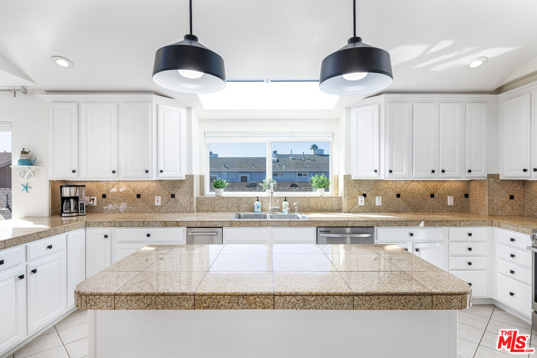 5101 Breakwater Way Oxnard, CA 93035 - Photo 7 of 39 a kitchen with stainless steel appliances granite countertop a sink a stove and cabinets