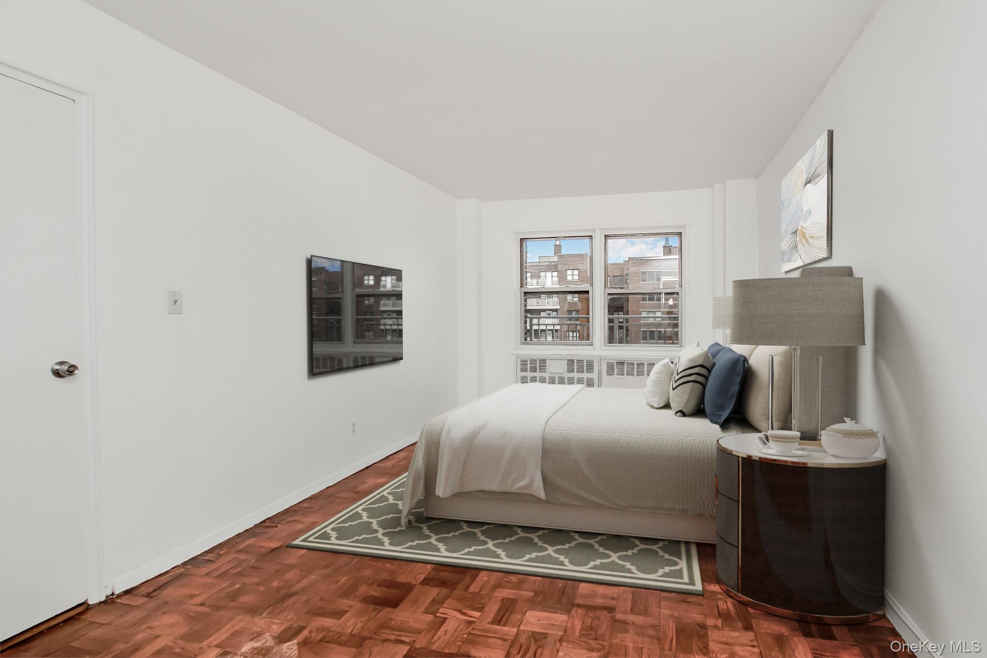 3131 Grand Concourse, Unit 5D Bronx, NY 10468 - Photo 12 of 22 a bedroom with a bed and wooden floor