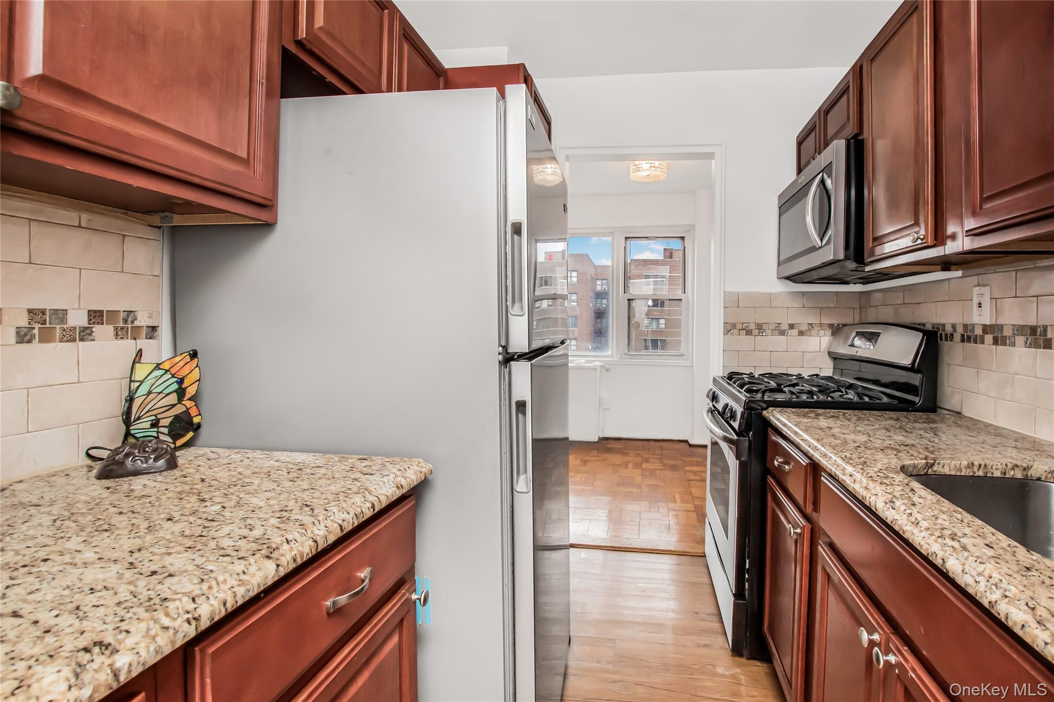 3131 Grand Concourse, Unit 5D Bronx, NY 10468 - Photo 6 of 22 a kitchen with stainless steel appliances granite countertop a sink stove and refrigerator