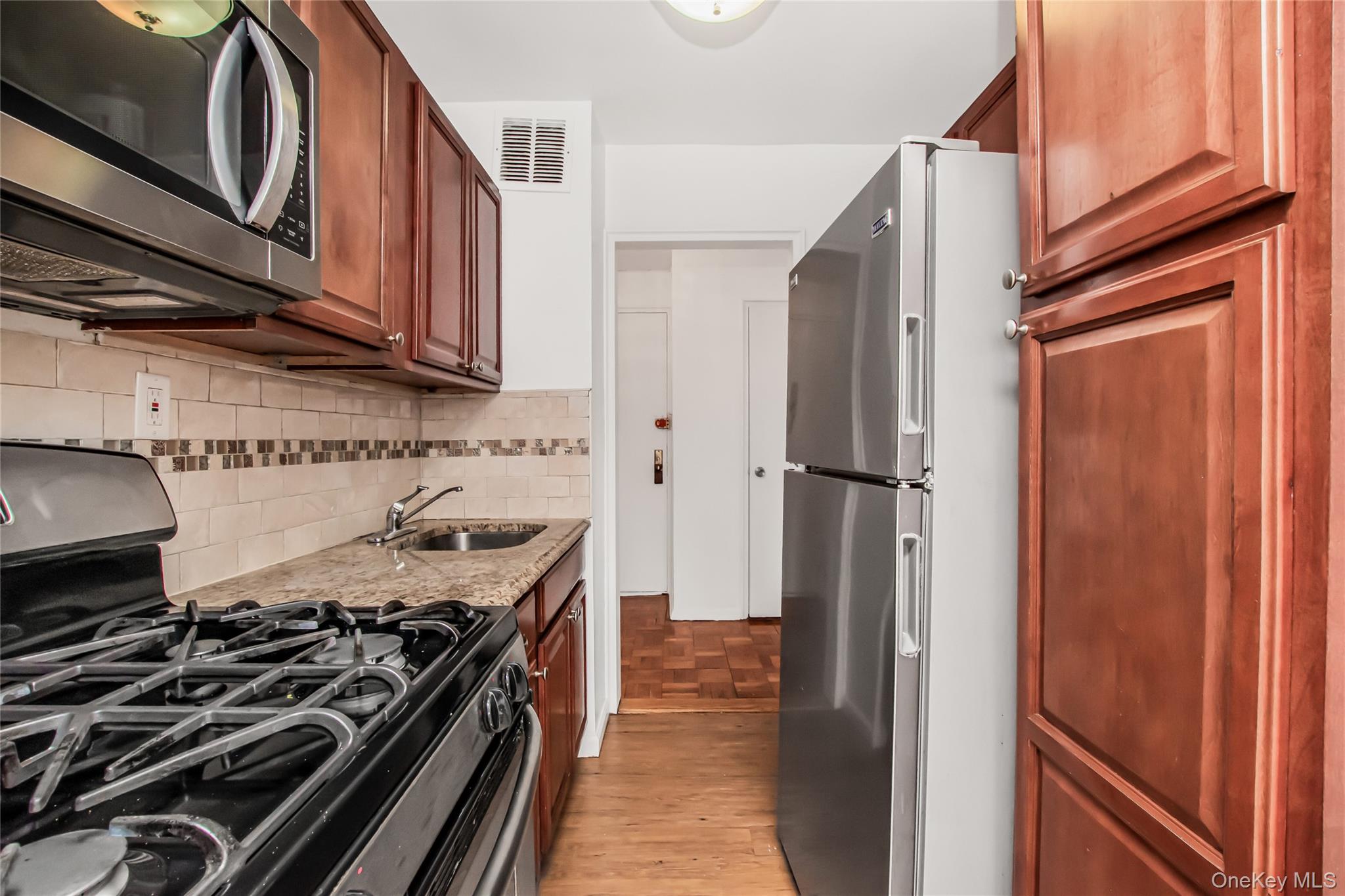 3131 Grand Concourse, Unit 5D Bronx, NY 10468 - Photo 7 of 22 a kitchen with a stove and a refrigerator