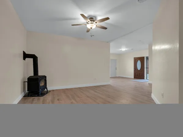 a living room with furniture and a ceiling fan