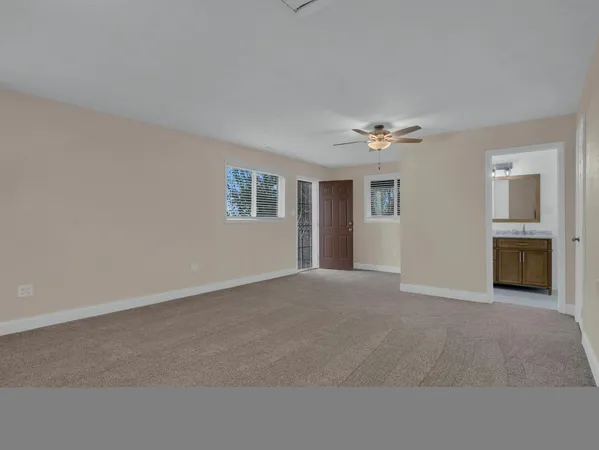 a view of a livingroom with a ceiling fan and window