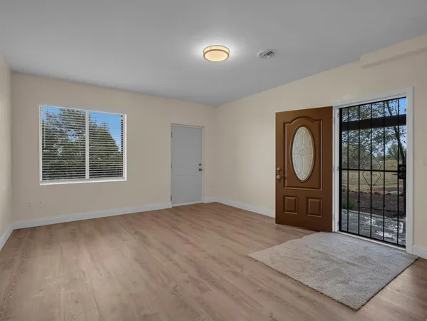 an empty room with windows and closet