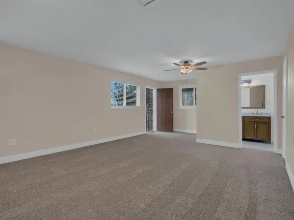 a view of a livingroom with a ceiling fan and window