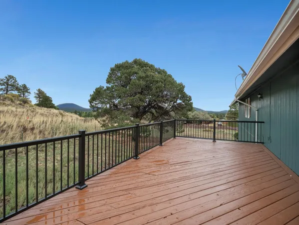 a view of balcony with wooden floor and fence