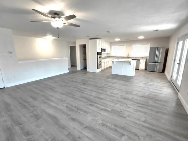 a view of a kitchen with a sink and a refrigerator
