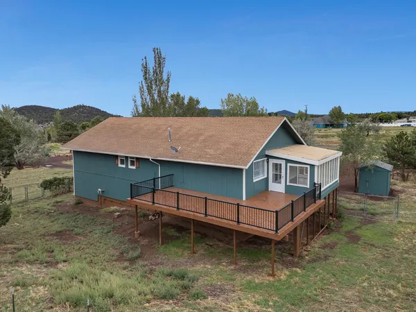 an aerial view of a house with roof deck front of house