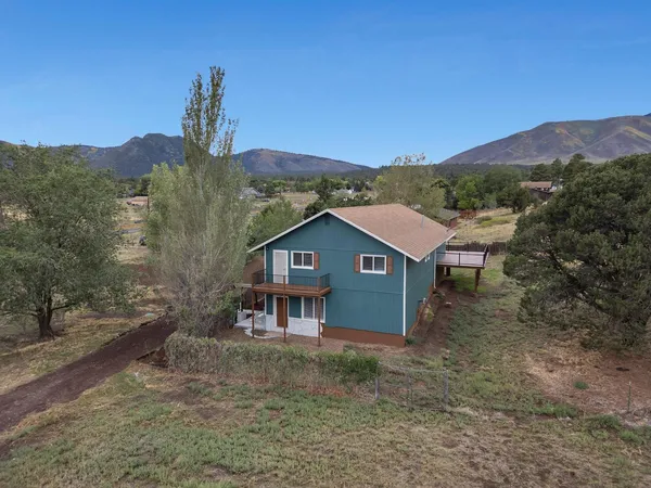 a view of a house with a backyard